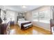 Bedroom with a dark wood bedframe, neutral walls, hardwood floors, and plenty of natural light from the windows at 1695 Arden Dr, Lincolnton, NC 28092