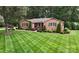 Charming brick home featuring a beautifully manicured lawn and lush landscaping at 1695 Arden Dr, Lincolnton, NC 28092