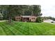 Beautiful brick home with manicured lawn, mature trees, and manicured landscaping creating a welcoming curb appeal at 1695 Arden Dr, Lincolnton, NC 28092