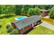 Aerial view of a brick home with a backyard pool and a spacious, tree-lined lawn at 1837 6Th Nw Ave, Hickory, NC 28601