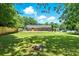 A backyard showcasing a well-maintained lawn, brick house, and firepit at 1837 6Th Nw Ave, Hickory, NC 28601