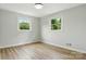 Bedroom showcasing natural light with its freshly painted neutral walls and wood flooring at 1837 6Th Nw Ave, Hickory, NC 28601