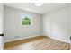 Bedroom showcasing its closet, window and neutral painted walls and wood flooring at 1837 6Th Nw Ave, Hickory, NC 28601