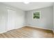 Bedroom showcasing its closet, window and neutral painted walls and wood flooring at 1837 6Th Nw Ave, Hickory, NC 28601