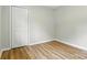 Bedroom showcasing its closet, and freshly painted neutral walls and wood flooring at 1837 6Th Nw Ave, Hickory, NC 28601