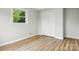 Bedroom showcasing its closet, window and neutral painted walls and wood flooring at 1837 6Th Nw Ave, Hickory, NC 28601