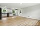Modern kitchen with white cabinets, black countertops, and sleek appliances, and wood flooring at 1837 6Th Nw Ave, Hickory, NC 28601