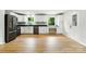 Modern kitchen with white cabinets, black countertops, sleek appliances, and wood flooring at 1837 6Th Nw Ave, Hickory, NC 28601
