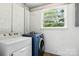 Laundry room with a washer and dryer, showcasing functional space with natural light from a window at 1837 6Th Nw Ave, Hickory, NC 28601