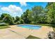 Backyard pool surrounded by lush greenery and concrete, perfect for outdoor relaxation and enjoyment at 1837 6Th Nw Ave, Hickory, NC 28601