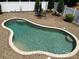 Expansive in-ground pool features a lounge area and a meticulously paved patio, creating an outdoor oasis at 1842 Caroline Way, Fort Mill, SC 29715