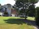 Spacious lot with a large home and a side-entry garage, accented by mature trees and a well-maintained lawn at 1842 Caroline Way, Fort Mill, SC 29715
