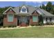 Charming brick home boasts meticulous landscaping and a welcoming front entrance, perfect for curb appeal at 1842 Caroline Way, Fort Mill, SC 29715