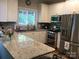Bright kitchen features granite countertops, stainless steel appliances, and white cabinetry at 1842 Caroline Way, Fort Mill, SC 29715