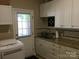 Practical laundry room featuring ample cabinetry and a convenient utility sink, combining functionality with style at 1842 Caroline Way, Fort Mill, SC 29715