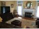 Comfortable living room boasts a beautiful fireplace and a plush leather seating arrangement at 1842 Caroline Way, Fort Mill, SC 29715