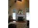 A cozy living room with a fireplace and two french doors and beautiful hardwood flooring at 1842 Caroline Way, Fort Mill, SC 29715