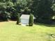 Backyard shed amidst a lush green lawn, providing functional storage and blending with the landscape at 1842 Caroline Way, Fort Mill, SC 29715
