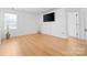 Bright bedroom with hardwood floors, a TV, and plenty of natural light from the windows at 2011 Valdosta Way, Charlotte, NC 28215