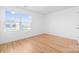 Well-lit bedroom with hardwood floors and a large window at 2011 Valdosta Way, Charlotte, NC 28215