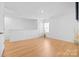 Large bonus room with hardwood floors, and ample natural light from the windows at 2011 Valdosta Way, Charlotte, NC 28215