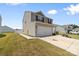 Home featuring an attached two-car garage, well-kept lawn, and a paved driveway at 2011 Valdosta Way, Charlotte, NC 28215