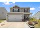 Charming two-story home with a two-car garage and neatly landscaped front yard at 2011 Valdosta Way, Charlotte, NC 28215