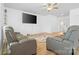 Comfortable living room with plush seating, ceiling fan, and large-screen television at 2011 Valdosta Way, Charlotte, NC 28215