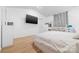 Bright main bedroom with wood floors, neutral walls, and TV mounted on the wall at 2011 Valdosta Way, Charlotte, NC 28215
