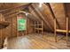 An unfinished attic features wood beams, a window, and exposed insulation at 202 Glenn Ave, Kannapolis, NC 28081