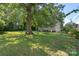 Large backyard featuring grass lawn with mature trees and green surroundings at 202 Glenn Ave, Kannapolis, NC 28081