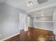 Spacious basement area featuring hardwood floors, grey walls, and bright lighting at 202 Glenn Ave, Kannapolis, NC 28081
