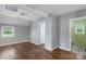 Large basement area with hardwood floors, gray walls, and door to bathroom at 202 Glenn Ave, Kannapolis, NC 28081