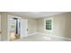 Neutral bedroom with carpet floors and bright window, next to open door to a room with dark blue walls at 202 Glenn Ave, Kannapolis, NC 28081