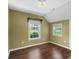 Cozy bedroom featuring hardwood floors, neutral colored walls, vaulted ceiling, and bright windows at 202 Glenn Ave, Kannapolis, NC 28081