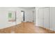 Bedroom features light wood floors, white walls, open closet, and lots of natural light at 202 Glenn Ave, Kannapolis, NC 28081