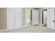 Spacious bedroom with neutral walls, carpet, with multiple doors, one leading to a room with stairs and chandelier at 202 Glenn Ave, Kannapolis, NC 28081