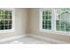 Bright bedroom featuring carpet floors, neutral walls, and large windows offering abundant natural light at 202 Glenn Ave, Kannapolis, NC 28081