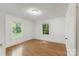 Bright, airy bedroom with hardwood floors, white walls, and windows providing natural light at 202 Glenn Ave, Kannapolis, NC 28081