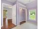 A purple bedroom features wood floors, a closet, and a view to another room at 202 Glenn Ave, Kannapolis, NC 28081