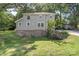 The home features a large lawn, a basement, and beautiful green surroundings at 202 Glenn Ave, Kannapolis, NC 28081
