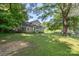 The home features a large lawn, mature trees and green surroundings at 202 Glenn Ave, Kannapolis, NC 28081