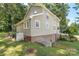 The home features a large lawn, basement, green surroundings and a side entrance at 202 Glenn Ave, Kannapolis, NC 28081