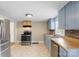 Well-lit kitchen features stainless steel appliances and blue lower cabinets at 202 Glenn Ave, Kannapolis, NC 28081