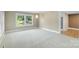 Bright living room with large windows, and neutral carpet flooring throughout at 202 Glenn Ave, Kannapolis, NC 28081