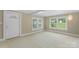 Spacious living room featuring light carpet flooring and natural light from large windows at 202 Glenn Ave, Kannapolis, NC 28081