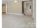 Open living area with neutral walls and flooring, doorway leads to stairs and upper level at 202 Glenn Ave, Kannapolis, NC 28081