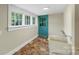 Practical mud room with a deep sink, bright natural light, and a blue door at 202 Glenn Ave, Kannapolis, NC 28081