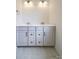 Elegant bathroom vanity with dual sinks, ample storage, and a light gray finish complements the tiled floor at 236 Paradise Dr, Belmont, NC 28012
