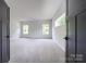 Expansive bedroom with neutral carpet, two windows, and elegant door frames; bright and airy space at 236 Paradise Dr, Belmont, NC 28012